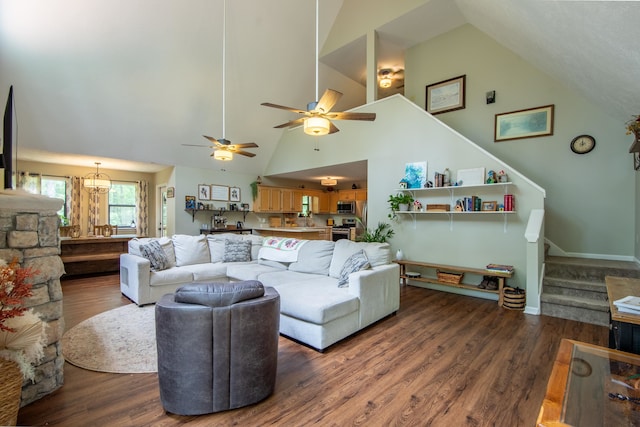 living room with high vaulted ceiling, ceiling fan with notable chandelier, and hardwood / wood-style floors