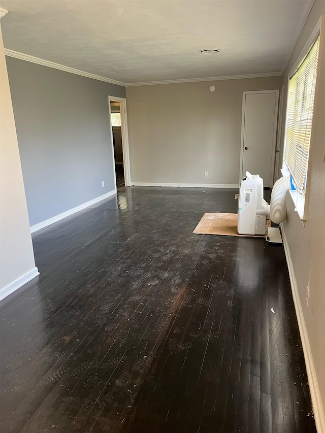 empty room featuring ornamental molding and dark wood-type flooring