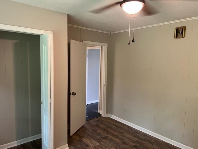 empty room featuring ceiling fan and dark hardwood / wood-style floors