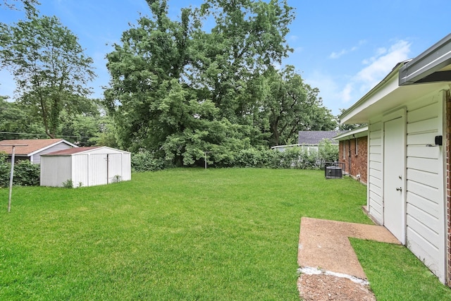 view of yard with a storage shed and central AC