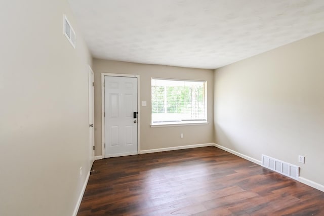 spare room featuring dark hardwood / wood-style floors