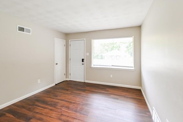 unfurnished room with dark hardwood / wood-style floors