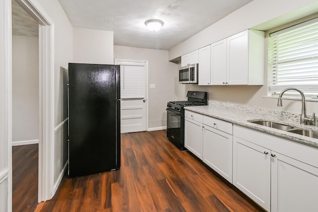 kitchen with dark hardwood / wood-style flooring, sink, white cabinetry, and black appliances