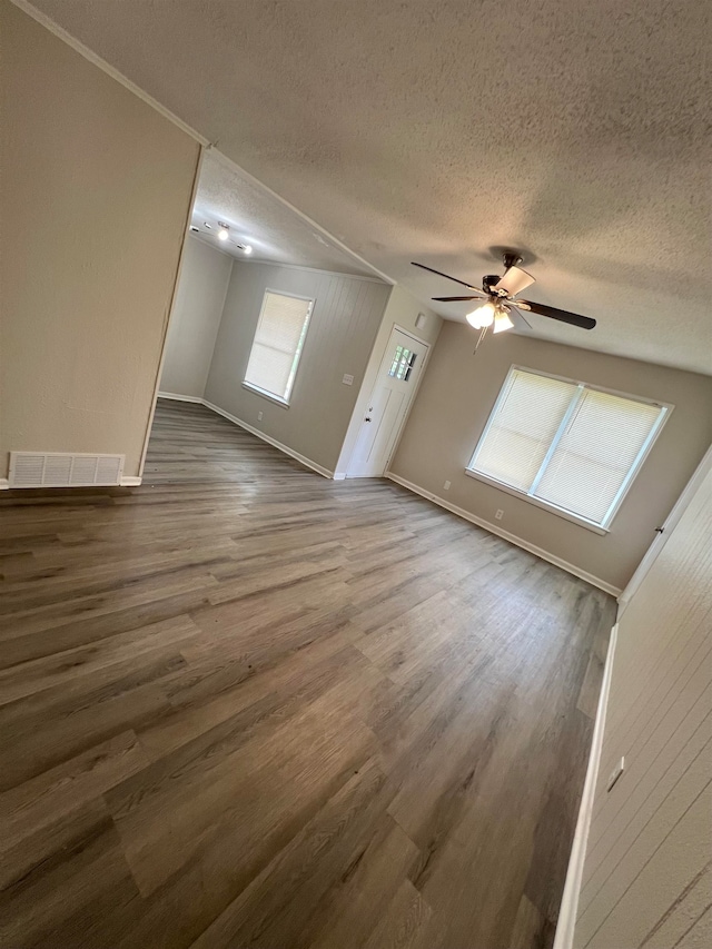 bonus room featuring a textured ceiling, dark hardwood / wood-style floors, and ceiling fan