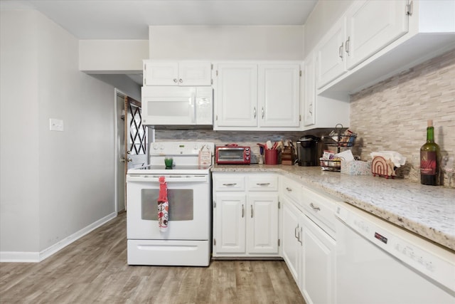 kitchen with white cabinetry, light stone countertops, white appliances, and backsplash