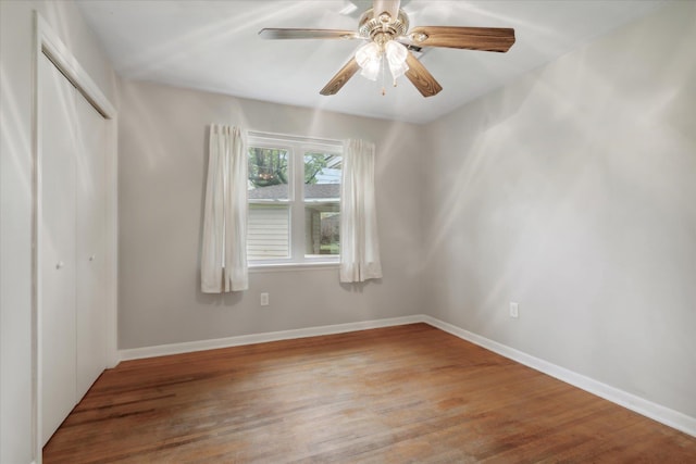 spare room featuring hardwood / wood-style floors and ceiling fan