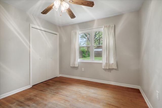 unfurnished bedroom with ceiling fan, light hardwood / wood-style floors, and a closet