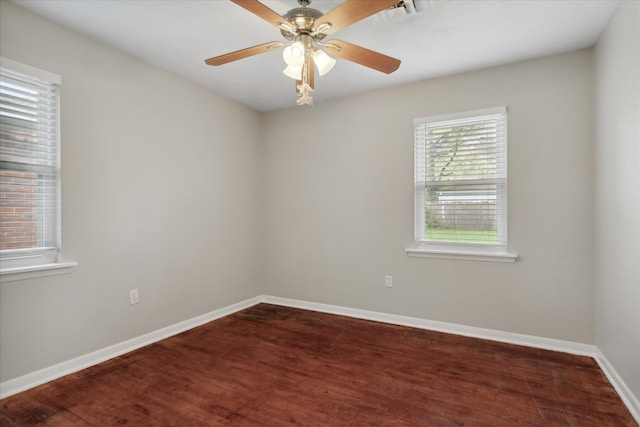 unfurnished room with dark hardwood / wood-style flooring and ceiling fan