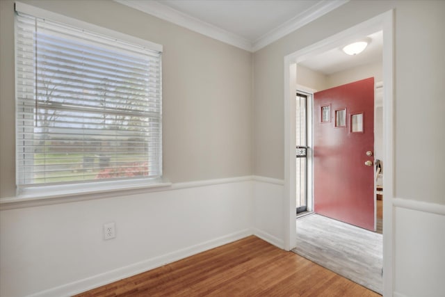 entryway featuring hardwood / wood-style floors, ornamental molding, and a wealth of natural light