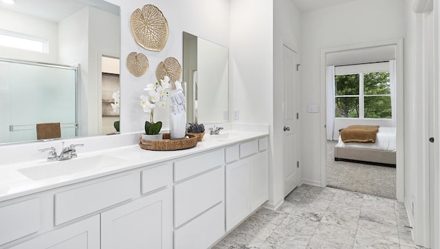 bathroom with vanity and a shower with shower door