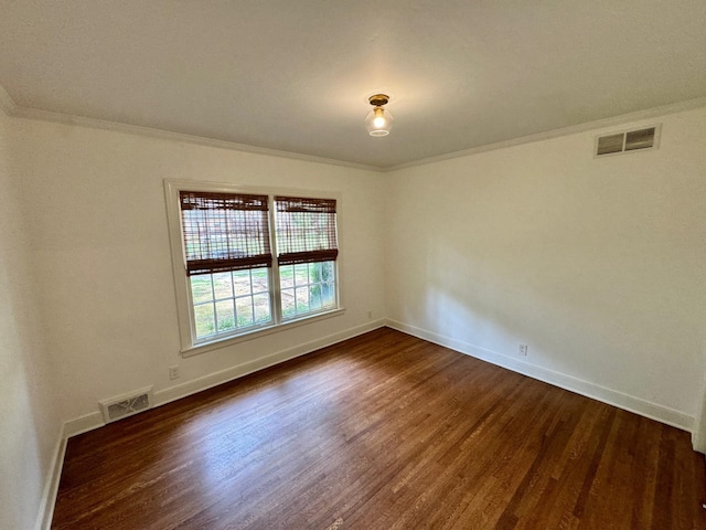 unfurnished room with dark wood-type flooring and ornamental molding