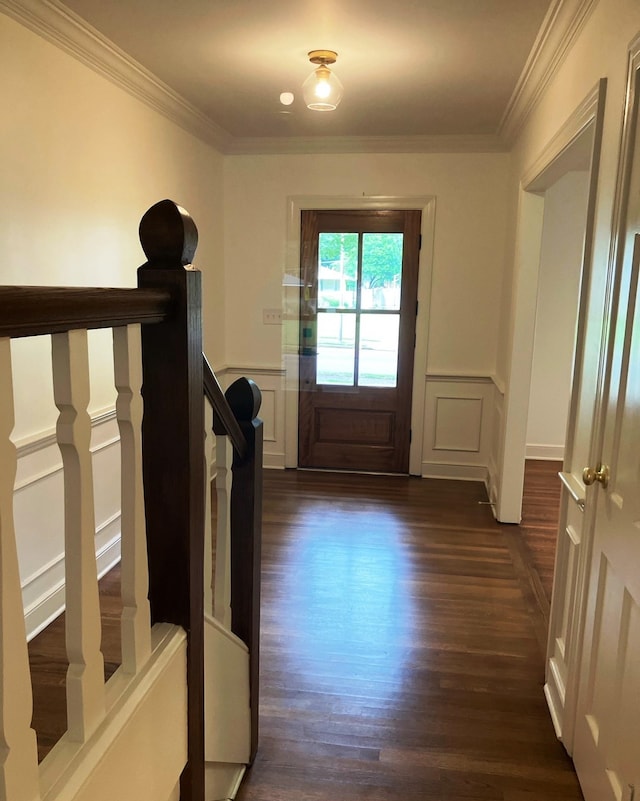 doorway with dark hardwood / wood-style floors and ornamental molding