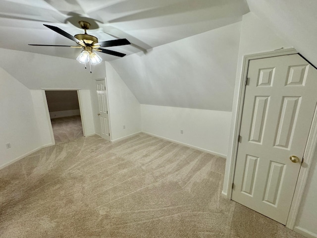 additional living space with light colored carpet, vaulted ceiling, and ceiling fan