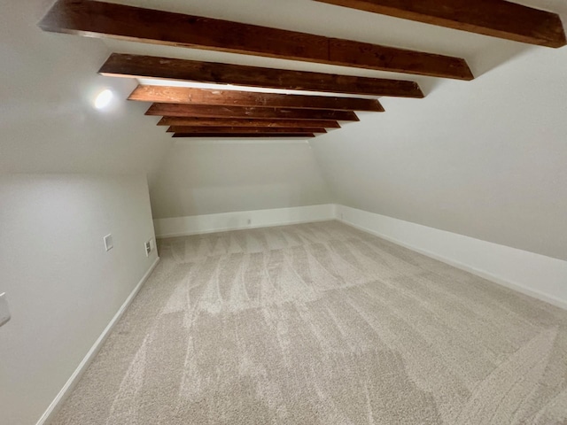 bonus room with vaulted ceiling with beams and light carpet