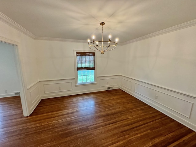 empty room featuring ornamental molding, dark wood-type flooring, and a chandelier