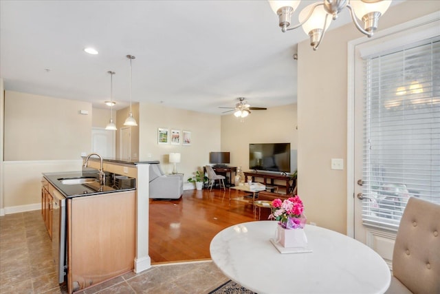 interior space with recessed lighting, baseboards, and ceiling fan with notable chandelier