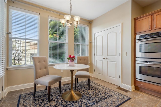 dining space with a chandelier, visible vents, baseboards, and light tile patterned flooring