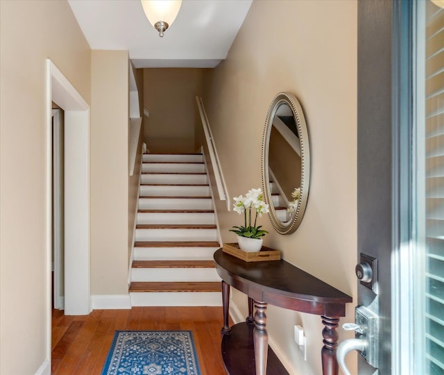 stairs with baseboards and wood finished floors