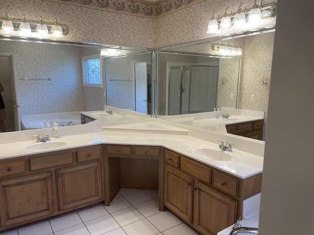 bathroom with a washtub, vanity, and tile patterned floors