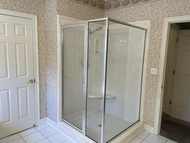 bathroom featuring tile patterned flooring and a shower with shower door