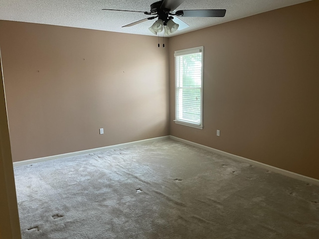 carpeted empty room with a textured ceiling and ceiling fan