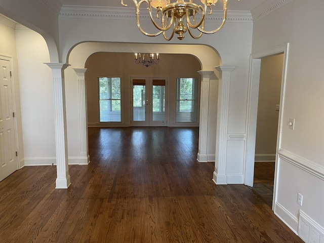 interior space featuring ornate columns, a wealth of natural light, and a notable chandelier