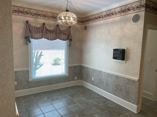 spare room featuring a chandelier and ornamental molding