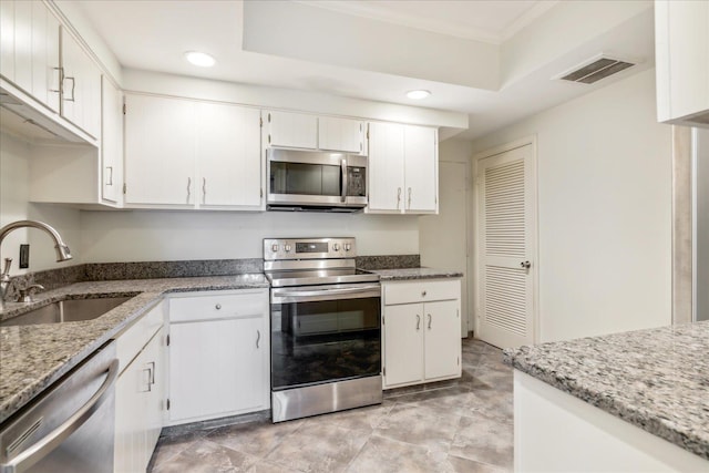 kitchen featuring light stone countertops, sink, white cabinetry, and stainless steel appliances