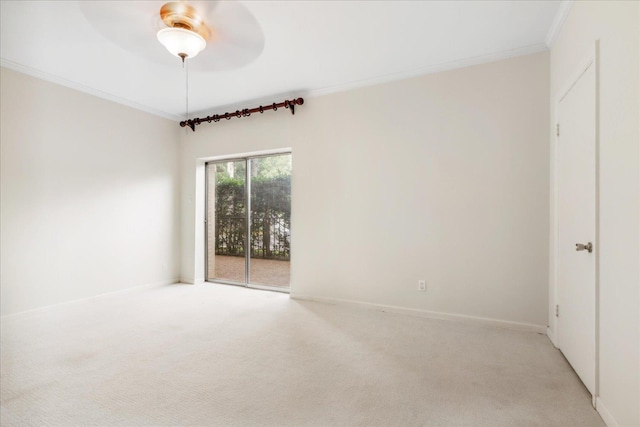 empty room with ceiling fan, crown molding, and light carpet