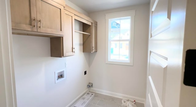 laundry area featuring hookup for a washing machine, cabinet space, and baseboards