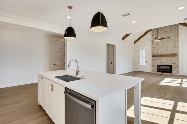 115 Independence Ln, Rossville, TN 38066 - kitchen with stainless steel dishwasher, vaulted ceiling, ceiling fan, light wood finished floors, and light stone counters