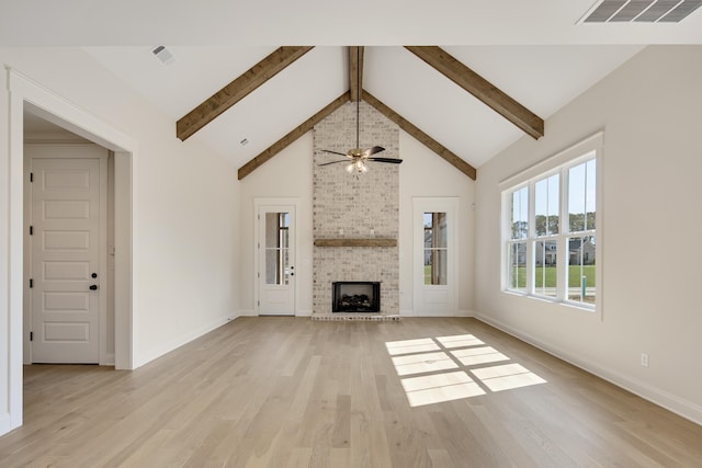 115 Independence Ln, Rossville, TN 38066 - unfurnished living room with light wood-type flooring, beamed ceiling, a ceiling fan, high vaulted ceiling, and a fireplace