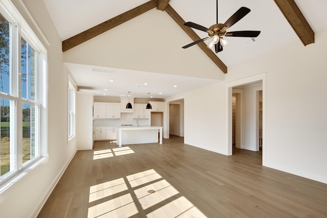 115 Independence Ln, Rossville, TN 38066 - unfurnished living room featuring beam ceiling, plenty of natural light, high vaulted ceiling, light wood-style floors, and ceiling fan