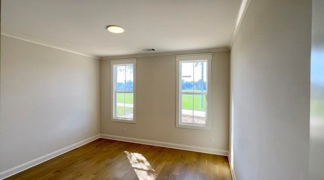 spare room with wood-type flooring and ornamental molding