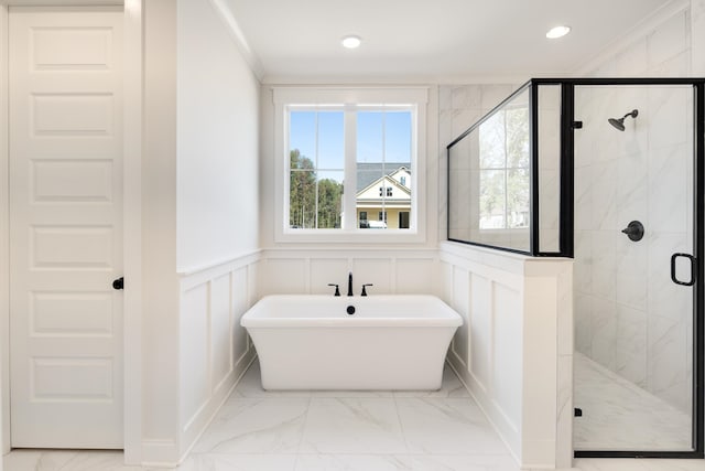 bathroom featuring ornamental molding, a stall shower, and marble finish floor