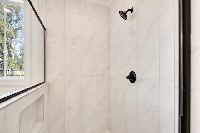 interior details with a tile shower