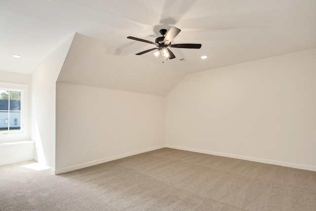 bonus room with carpet flooring, vaulted ceiling, and ceiling fan