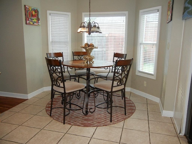 dining room featuring light tile patterned floors and an inviting chandelier