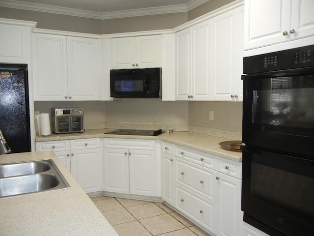 kitchen with light tile patterned floors, white cabinetry, ornamental molding, and black appliances