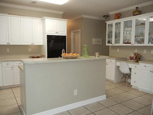 kitchen with a kitchen island, white cabinetry, crown molding, and light tile patterned floors