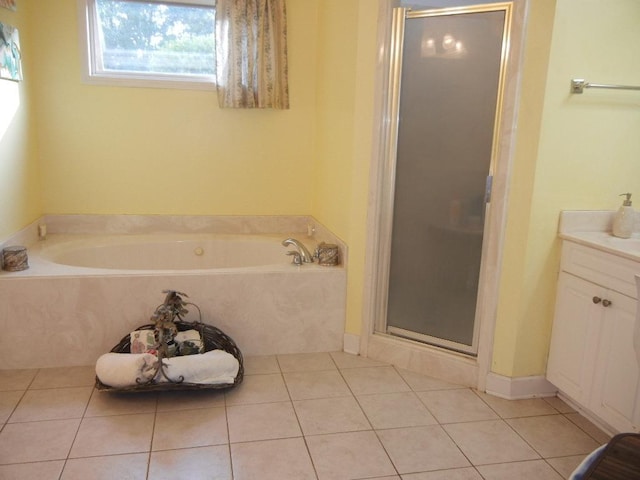 bathroom with tile patterned flooring, vanity, and independent shower and bath