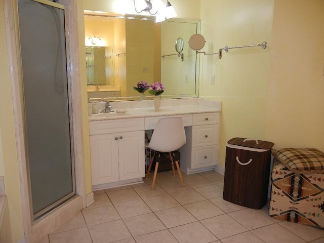 bathroom featuring tile patterned flooring, vanity, and a shower with door