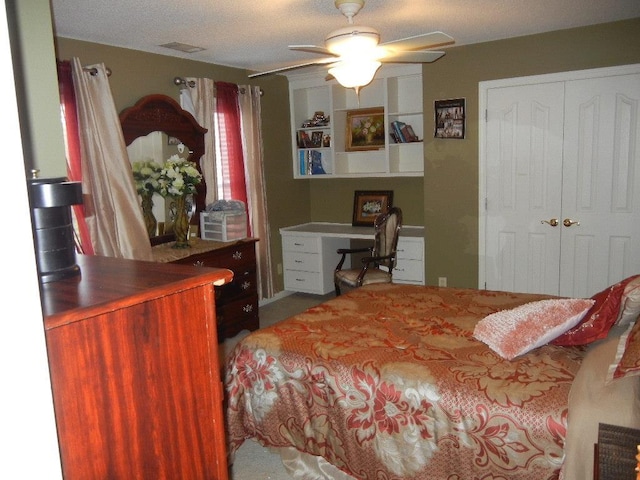 bedroom with a textured ceiling, a closet, and ceiling fan