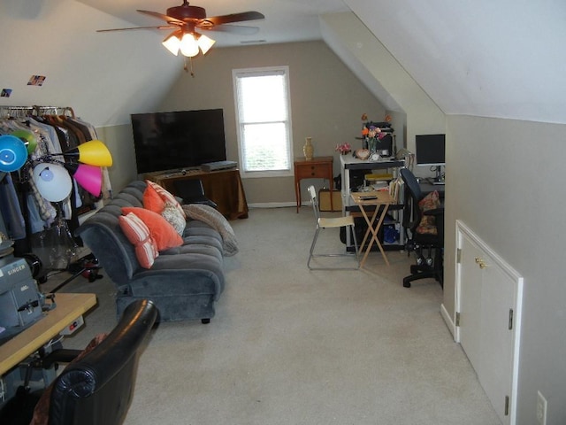 carpeted office space with vaulted ceiling and ceiling fan