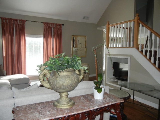 living room featuring hardwood / wood-style flooring and vaulted ceiling