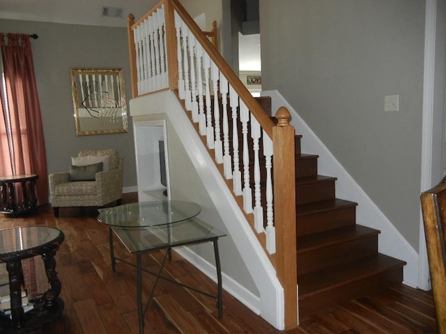 staircase with hardwood / wood-style flooring