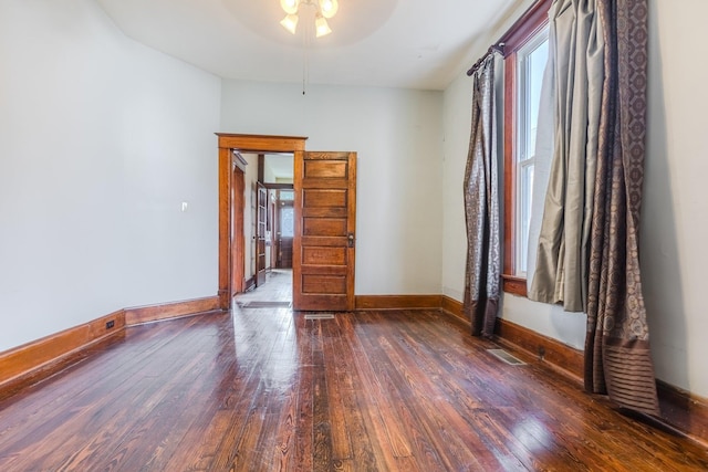 unfurnished room featuring dark wood-type flooring