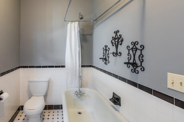 bathroom featuring shower / bath combination with curtain, toilet, and tile walls