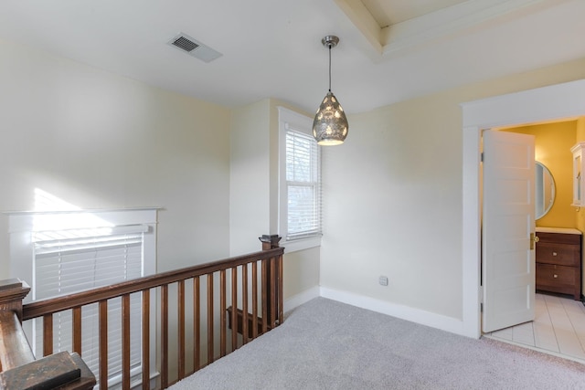 hall featuring light colored carpet