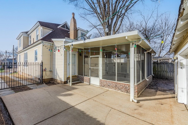 rear view of property with a sunroom